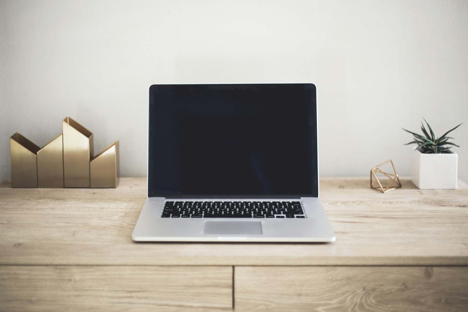 A tidy home-office desk with a laptop