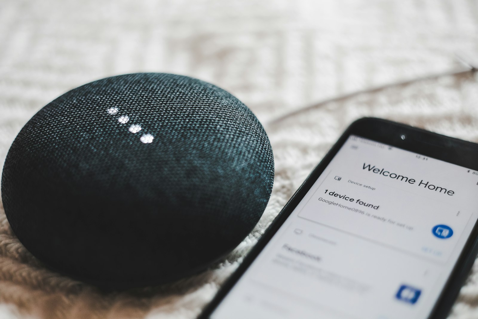 Smart speaker being set up next to a phone